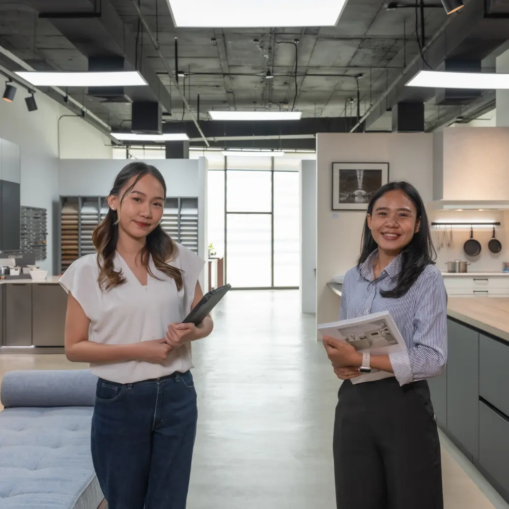 Two German Kitchen Design team members in the River City Bangkok showroom, ready to help