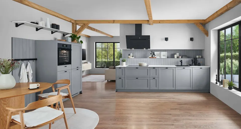 Cottage kitchen in soft gray under exposed wooden beams