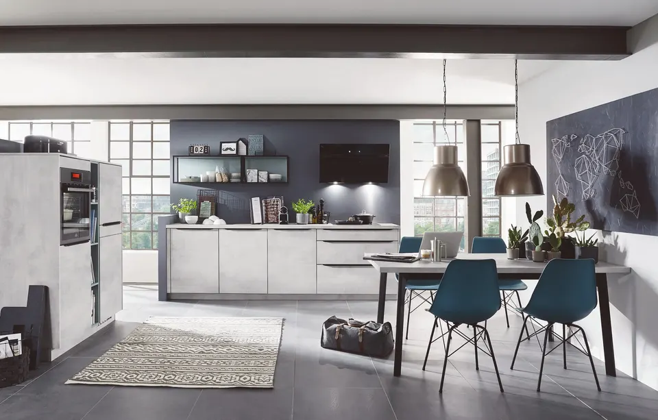 Modern kitchen with concrete-look cabinetry and an open-plan dining area